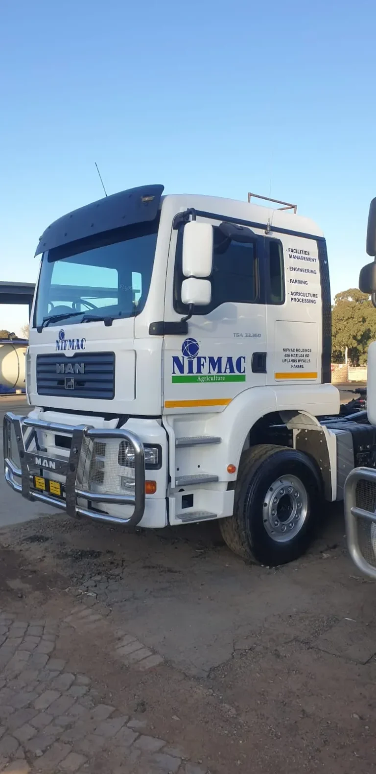 MAN truck cab branded with company logo and services by Signpartners